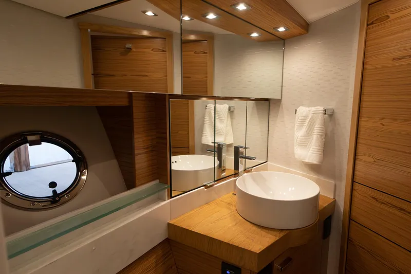 Slide: The Image of Luxurious bathroom in 2023 Tiara Yachts C44 Coupe with modern fixtures and wood accents. - 37