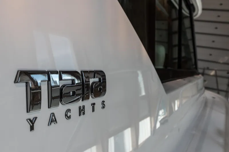 Slide: The Image of 2023 Tiara Yachts C44 Coupe logo on sleek white hull. - 42