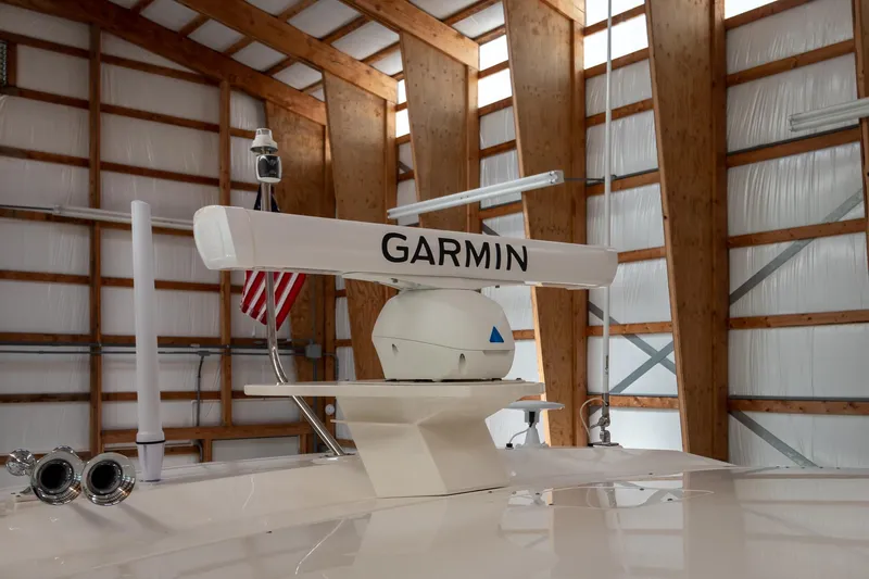 Slide: The Image of 2023 Tiara Yachts C44 Coupe with Garmin radar in a wooden boathouse. - 43