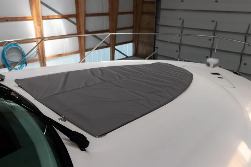 Slide: The Image of 2023 Tiara Yachts C44 Coupe with protective cover on deck in storage. - 44