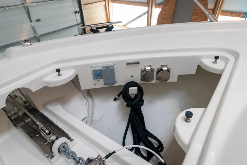 Slide: The Image of 2023 Tiara Yachts C44 Coupe deck with anchor chain and control panel. - 45