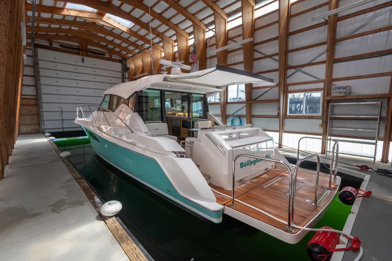 Slide: The Image of 2023 Tiara Yachts C44 Coupe in a boathouse, showcasing sleek design and luxury features. - 6
