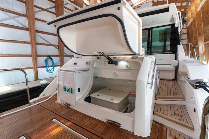 Slide: The Image of 2023 Tiara Yachts C44 Coupe with open storage compartment on teak deck. - 9