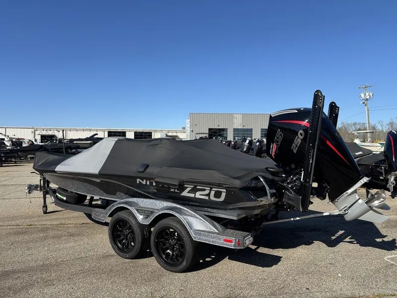 Slide: The Image of 2025 Nitro Z20 XL Pro boat with cover on trailer, parked outdoors. - 23