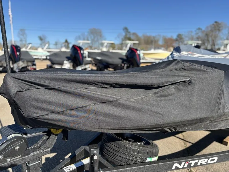 Slide: The Image of Covered Nitro Z20 XL Pro boat, 2025 model, on trailer in outdoor setting. - 24