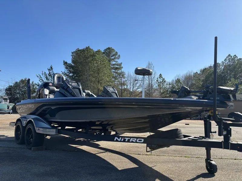 Slide: The Image of 2025 Nitro Z20 XL Pro boat on trailer, parked outdoors under clear blue sky. - 7