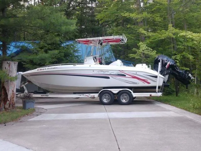 Slide: The Image of 2005 Baja 250 Sportfish Center Console boat on trailer, surrounded by trees. - 1