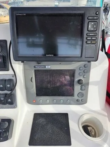 Slide: The Image of 2005 Baja 250 Sportfish Center Console with Garmin and Raymarine navigation displays. - 27