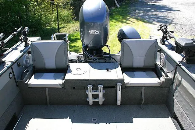 Slide: The Image of 2012 Alumacraft Trophy 205 Sport boat interior with Yamaha 150 engine, dual seats, and fishing equipment. - 11