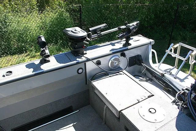 Slide: The Image of 2012 Alumacraft Trophy 205 Sport boat interior with fishing equipment and storage compartments. - 13