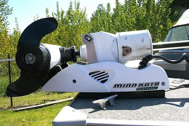 Slide: The Image of Minn Kota trolling motor on 2012 Alumacraft Trophy 205 Sport boat deck. - 15