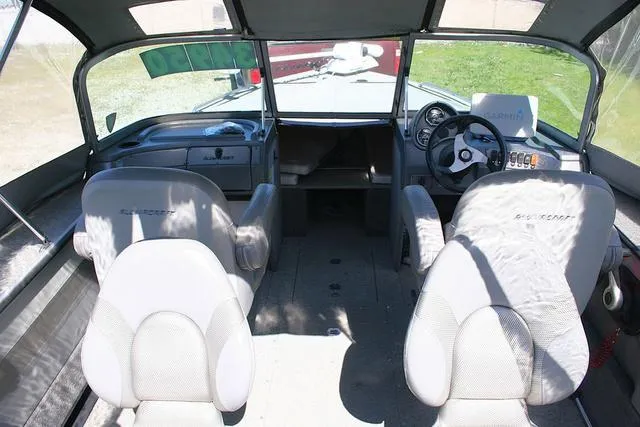Slide: The Image of 2012 Alumacraft Trophy 205 Sport boat interior with steering wheel and seating. - 5