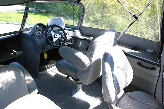 Slide: The Image of 2012 Alumacraft Trophy 205 Sport boat interior with steering wheel and seating. - 6