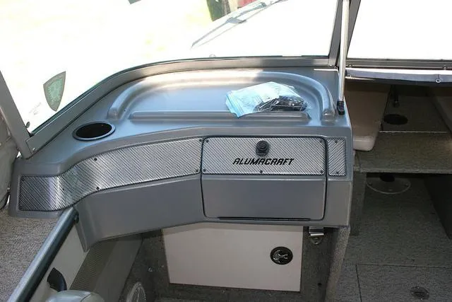 Slide: The Image of 2012 Alumacraft Trophy 205 Sport boat interior with dashboard and storage compartment. - 9
