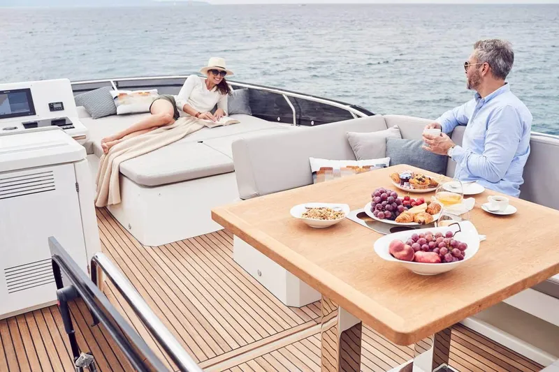 Slide: The Image of Couple enjoying breakfast on 2024 Prestige 520 Fly yacht deck, with ocean view. - 11