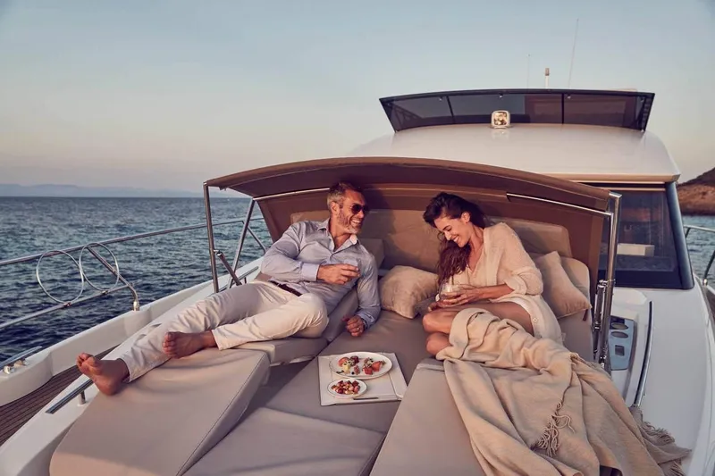 Slide: The Image of Couple relaxing on 2024 Prestige 520 Fly yacht, enjoying a meal at sea. - 10