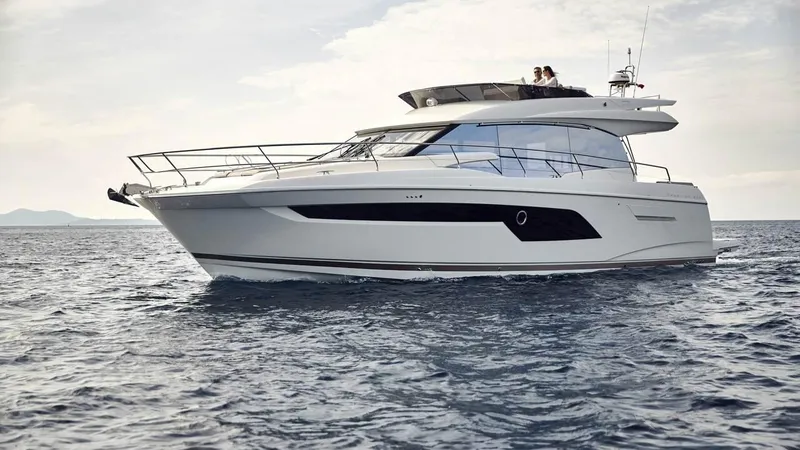Slide: The Image of 2024 Prestige 520 Fly yacht cruising on open water. - 2