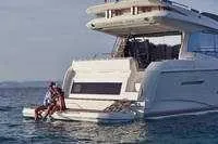 Slide: The Image of 2024 Prestige 520 Fly yacht with people enjoying the water at the stern. - 5