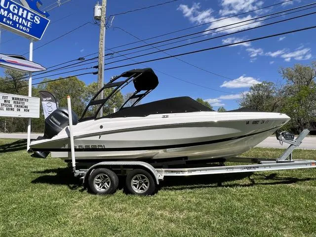Slide: The Image of 2020 Regal 21 OBX boat on trailer, displayed outdoors at Hughes Marine. - 1