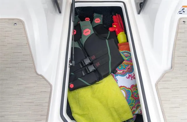 Slide: The Image of 2020 Regal 21 OBX boat interior with beige seating, on calm water. - 11