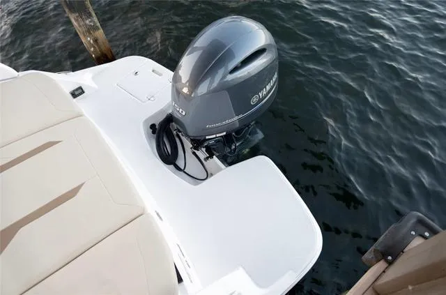 Slide: The Image of Open storage compartment in 2020 Regal 21 OBX boat with sports gear and towels. - 14