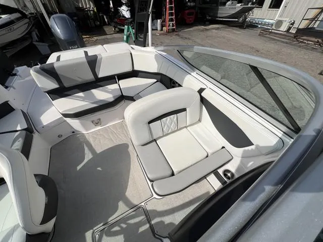 Slide: The Image of 2020 Regal 21 OBX boat interior with white seating and open deck layout. - 23