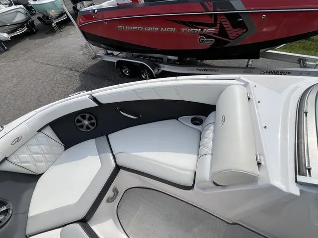 Slide: The Image of 2020 Regal 21 OBX boat interior with cushioned seating and speaker system. - 25