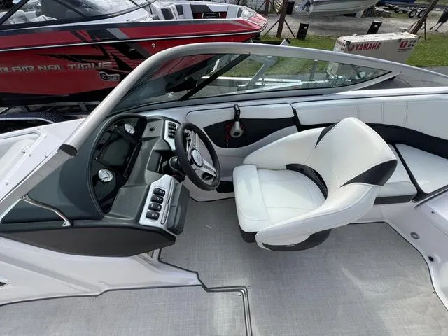 Slide: The Image of 2020 Regal 21 OBX boat interior with sleek dashboard and comfortable seating. - 27