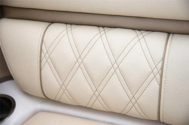 Slide: The Image of 2020 Regal 21 OBX boat interior with beige seating, on calm water. - 7