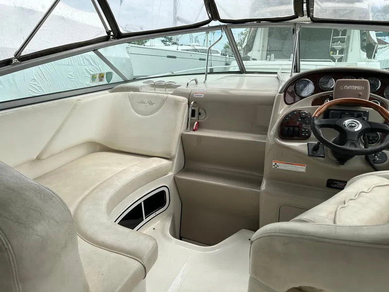Slide: The Image of Interior view of 2006 Sea Ray 280 Sundancer boat cockpit with steering wheel and seating. - 12