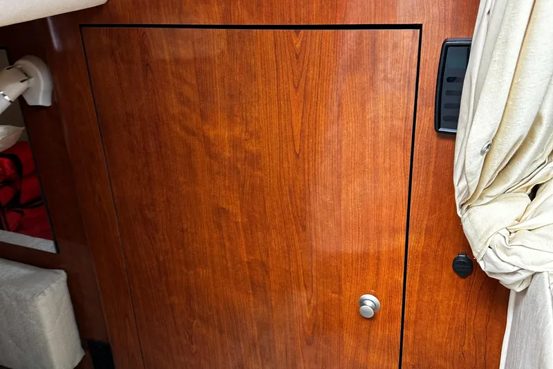 Slide: The Image of Wooden cabin door inside a 2006 Sea Ray 280 Sundancer boat. - 16