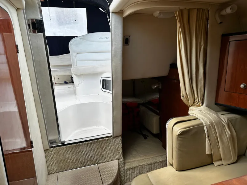 Slide: The Image of Interior of 2006 Sea Ray 280 Sundancer boat, featuring seating and cabin entrance. - 23