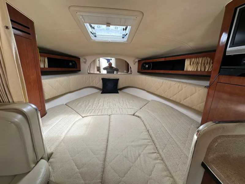 Slide: The Image of Interior cabin of 2006 Sea Ray 280 Sundancer with beige upholstery and wood accents. - 26