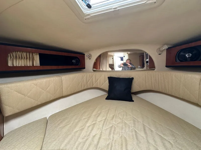 Slide: The Image of Interior cabin of 2006 Sea Ray 280 Sundancer with beige upholstery and black pillow. - 27