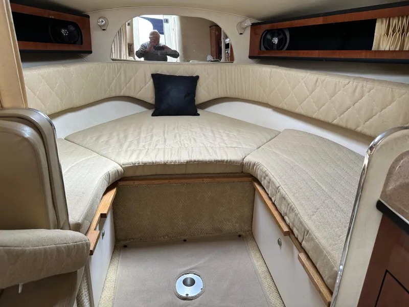 Slide: The Image of Interior cabin of 2006 Sea Ray 280 Sundancer with beige upholstery and black pillow. - 29
