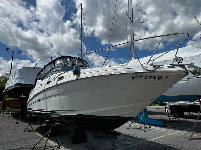 Slide: The Image of 2006 Sea Ray 280 Sundancer boat on dry dock under cloudy sky. - 3