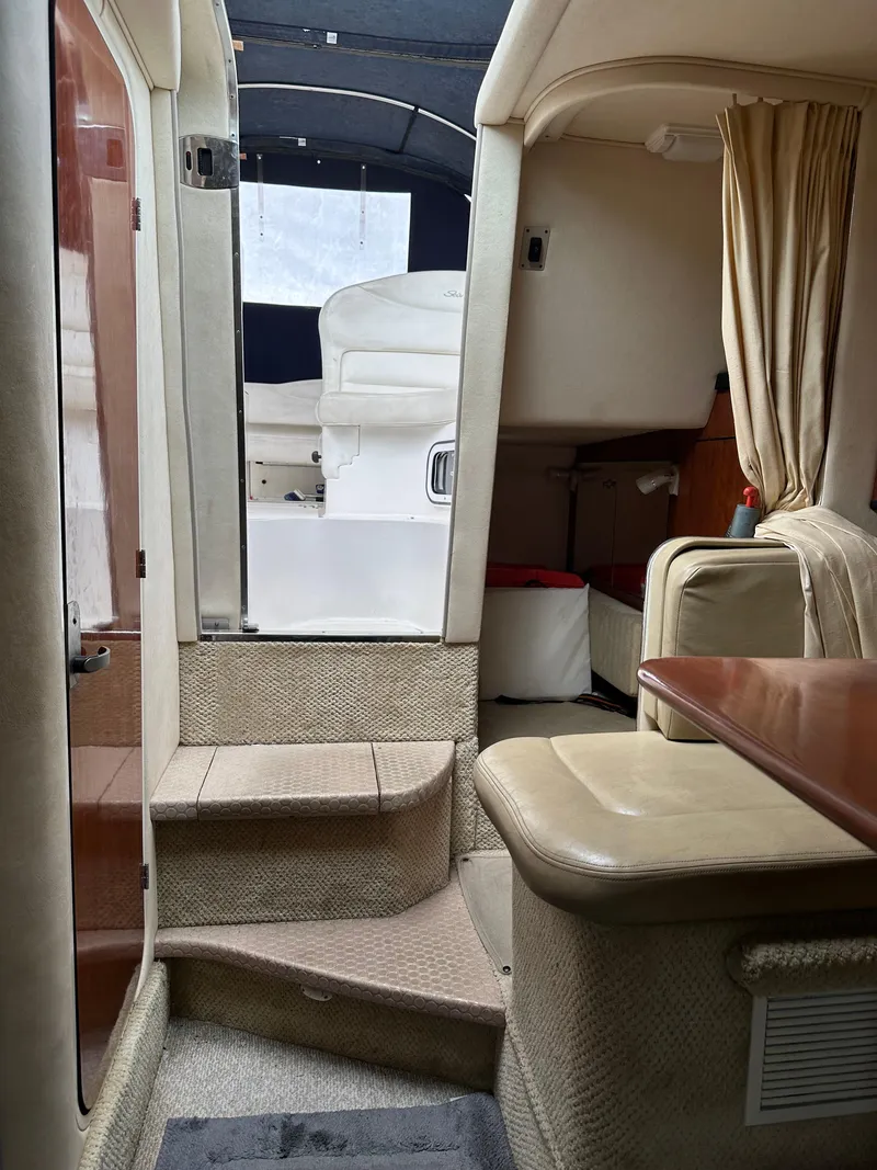 Slide: The Image of Interior of 2006 Sea Ray 280 Sundancer boat, featuring seating and cabin area. - 32