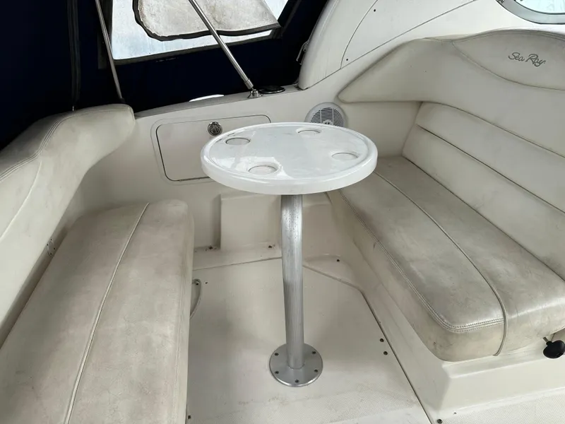 Slide: The Image of 2006 Sea Ray 280 Sundancer interior with white seating and small round table. - 34