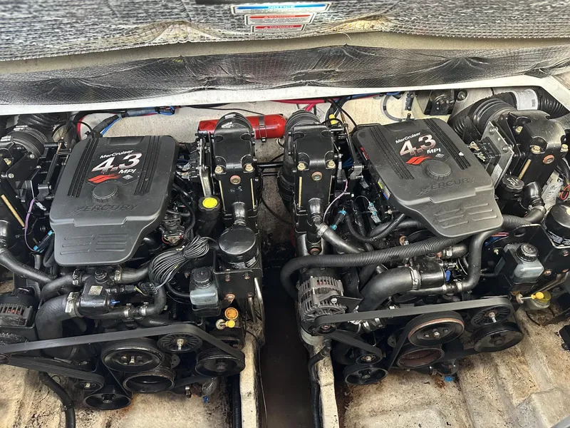 Slide: The Image of Twin engines of a 2006 Sea Ray 280 Sundancer boat, showcasing 4.3 MPI motors. - 36
