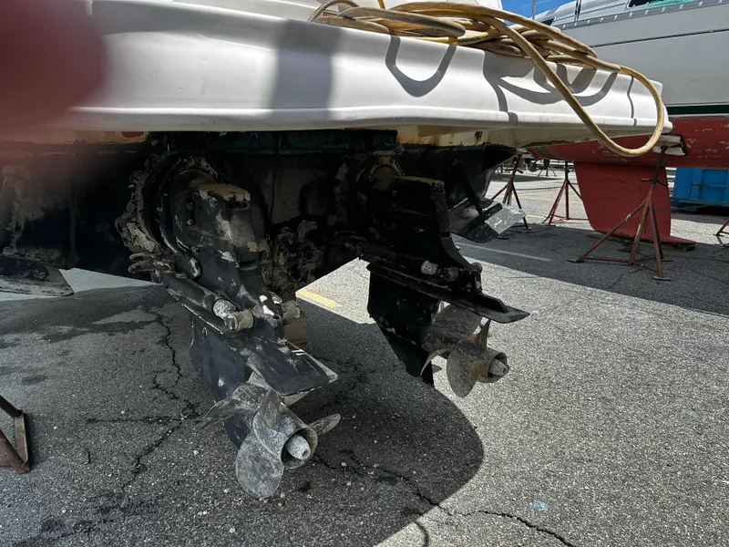 Slide: The Image of 2006 Sea Ray 280 Sundancer boat with visible outboard motors on a dry dock. - 37