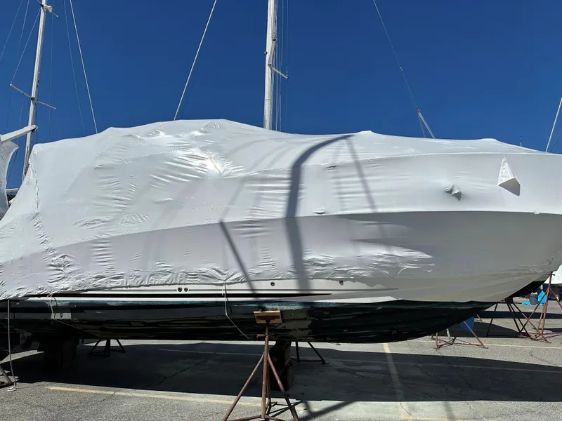 Slide: The Image of Covered 2006 Sea Ray 280 Sundancer boat on stands under clear blue sky. - 38