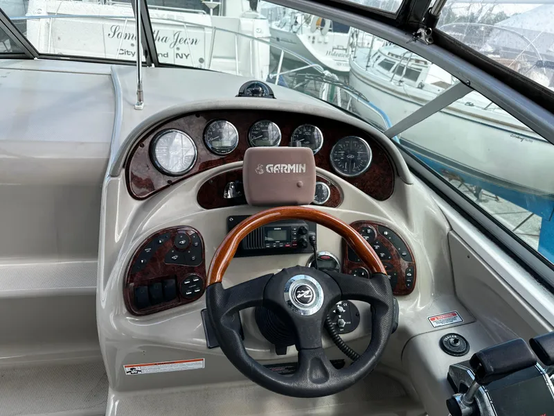 Slide: The Image of 2006 Sea Ray 280 Sundancer helm with Garmin navigation and wood-accented steering wheel. - 7