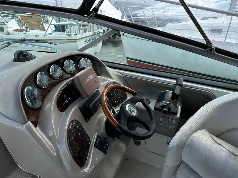 Slide: The Image of 2006 Sea Ray 280 Sundancer helm with gauges and steering wheel. - 8