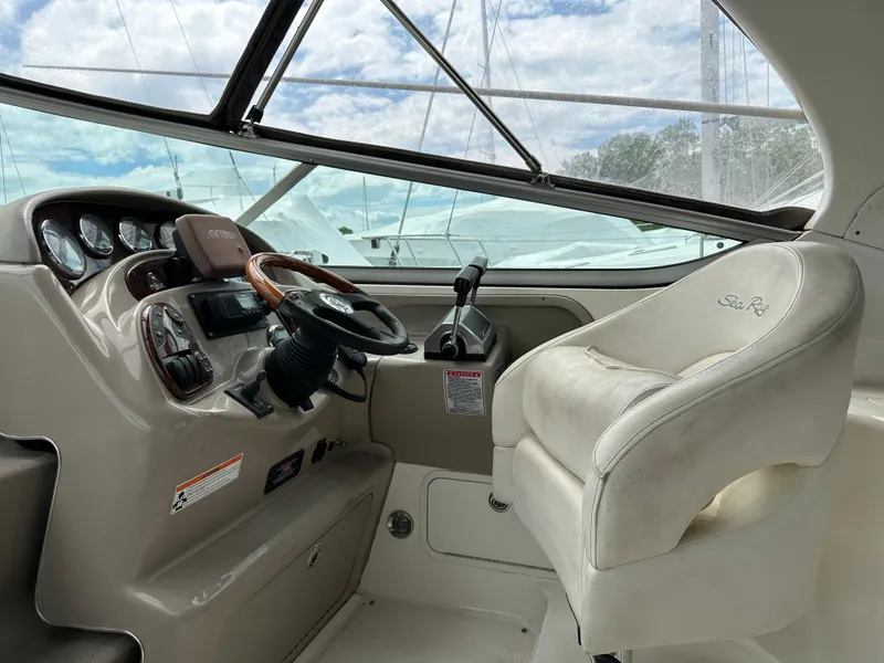 Slide: The Image of 2006 Sea Ray 280 Sundancer helm with steering wheel and captain's chair. - 9