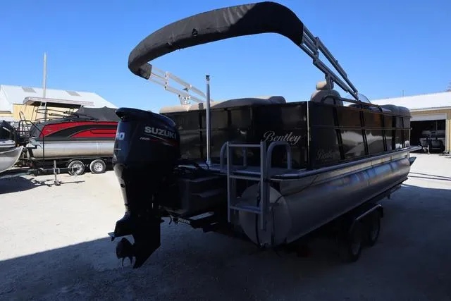 Slide: The Image of 2018 Bentley Pontoons Legacy 223 Cruise SE with Suzuki outboard motor, parked outdoors. - 4