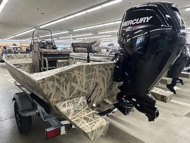 Slide: The Image of 2025 Lowe RX1870 Pathfinder boat with Mercury engine, camo design, displayed indoors. - 11