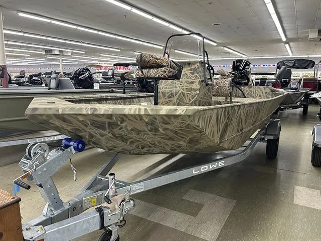 Slide: The Image of 2025 Lowe RX1870 Pathfinder boat with camouflage design on display in showroom. - 3