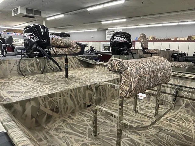 Slide: The Image of 2025 Lowe RX1870 Pathfinder boat with camo seats and Mercury outboard motors in showroom. - 4