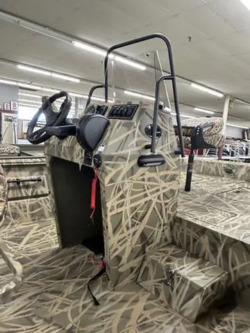 Slide: The Image of 2025 Lowe RX1870 Pathfinder boat interior with camouflage design and steering console. - 6