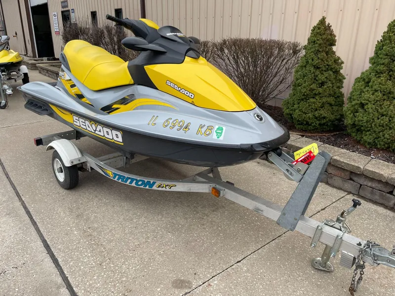 Slide: The Image of 2007 Sea-Doo GTI SE 155 jet ski on trailer, yellow and gray design. - 1